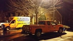 Water Damage Restoration Trucks Parked At Residential Job Site At Night