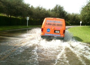 Water Damage Restoration Van Driving Down Flooded Street